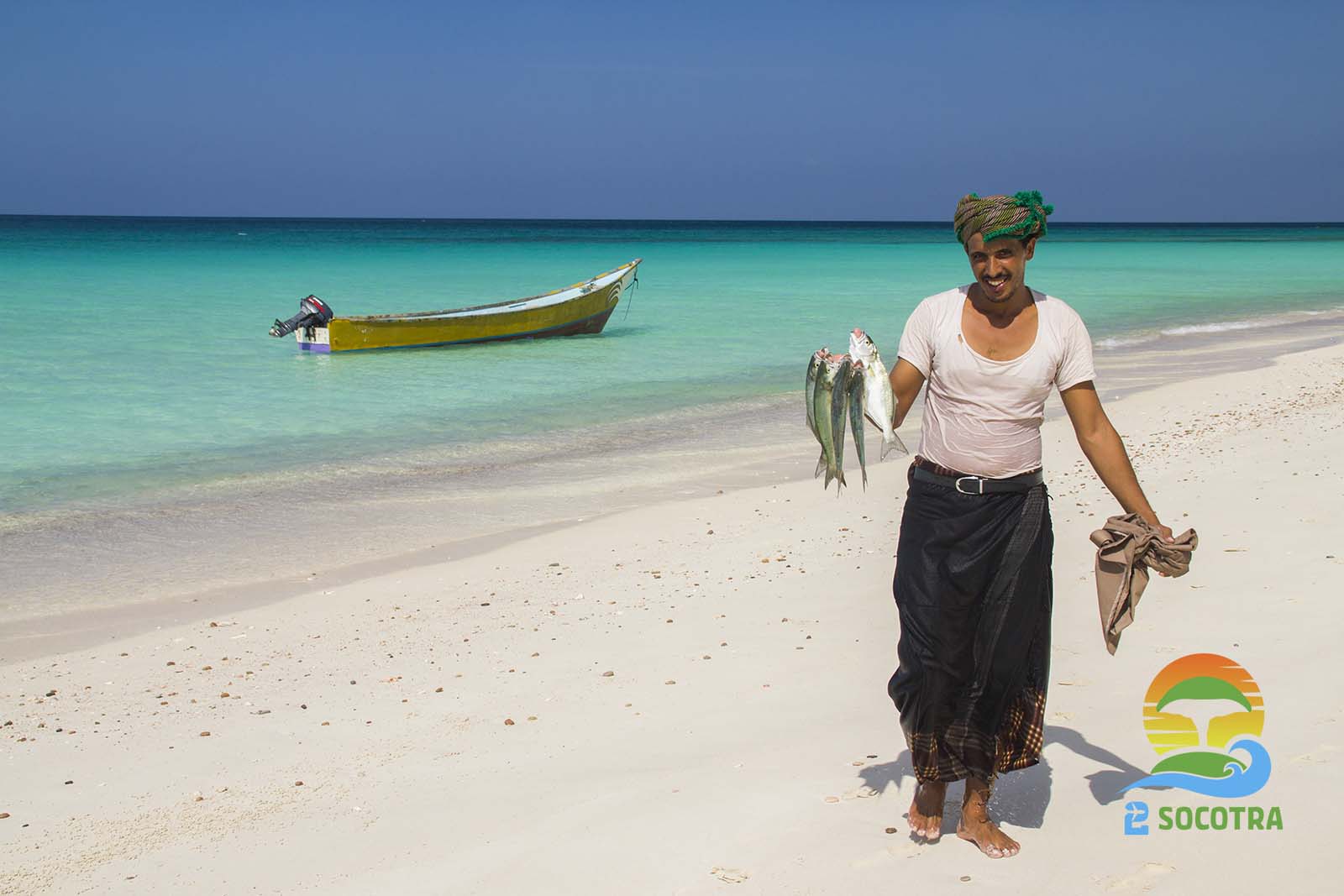 Shoab Beach , man holding Fish , boat - Shuab Bay Socotra