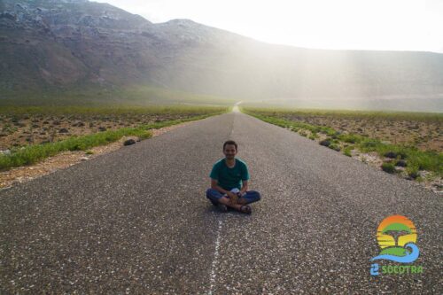 A tourist in Socotra sitting on the road, Tourist is attracted to places like Socotra Island
